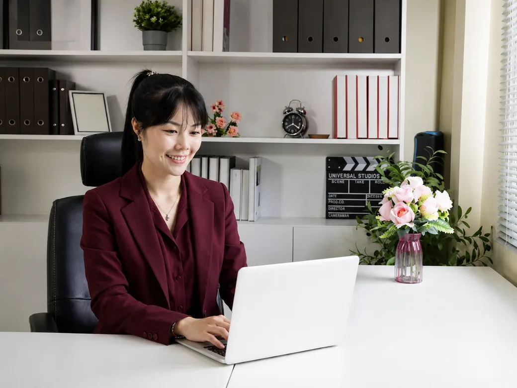 University administrators reviewing signed documents together in an office