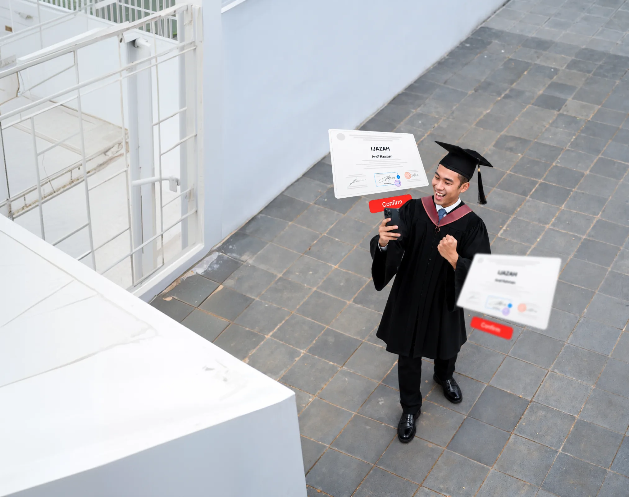 A graduate in cap and gown holding a digitally certified diploma at a campus ceremony
