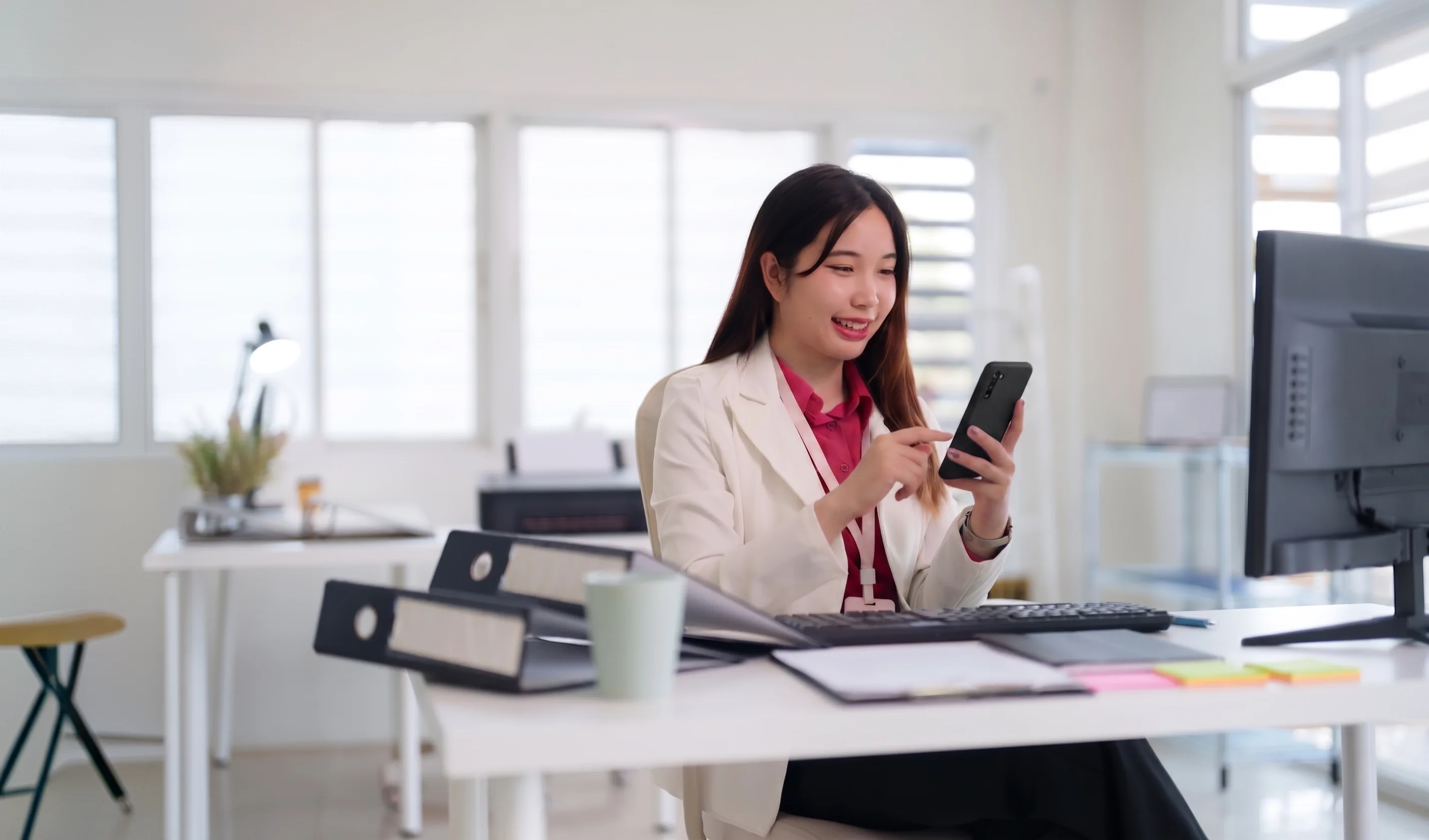 A woman checking her loan application on a smartphone
